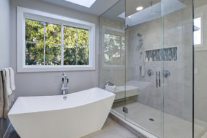 Glass walk-in shower in a bathroom of new luxury home